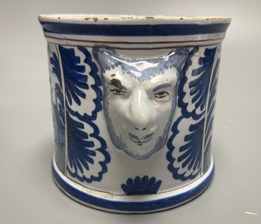 An 18th/19th century Delft blue and white jar and cover, with bearded mask handles, 17cm